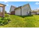 Home's backyard featuring lush green grass and well-maintained landscaping at 10938 E Mount Vernon N Trl, Indianapolis, IN 46229