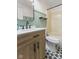 Stylish bathroom featuring a vanity with modern fixtures, patterned tile flooring, and a shower-tub combo at 10938 E Mount Vernon N Trl, Indianapolis, IN 46229
