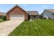 Charming home with a brick facade, attached garage, and well-manicured front lawn at 10938 E Mount Vernon N Trl, Indianapolis, IN 46229