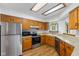 Spacious kitchen features stainless appliances, wood cabinetry, and granite countertops at 10938 E Mount Vernon N Trl, Indianapolis, IN 46229