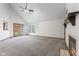 Bright living room with neutral carpet, a ceiling fan, a fireplace and sliding glass doors at 10938 E Mount Vernon N Trl, Indianapolis, IN 46229