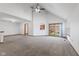 Expansive living room featuring plush carpeting, high ceilings, and sliding glass doors at 10938 E Mount Vernon N Trl, Indianapolis, IN 46229