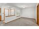 Bright living room with fresh paint, new carpet, and window with half-wall partition at 10938 E Mount Vernon N Trl, Indianapolis, IN 46229