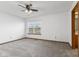 This main bedroom features fresh paint, new carpet, and a window with backyard views at 10938 E Mount Vernon N Trl, Indianapolis, IN 46229