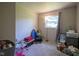 A bedroom with carpet flooring, wood-paneled walls and one window at 11 Sayre Dr, Greenwood, IN 46143