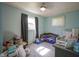 Bedroom features a crib, chair, and two windows at 11 Sayre Dr, Greenwood, IN 46143