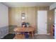 Cozy dining area with a wooden table, two chairs, a dog cage, and wood-paneled walls at 11 Sayre Dr, Greenwood, IN 46143