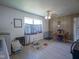 Open space with dining area, white and wood-paneled walls, a window, and ceiling fan at 11 Sayre Dr, Greenwood, IN 46143