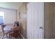 Small dining area with a wooden table and chairs, wood paneled walls and a white door at 11 Sayre Dr, Greenwood, IN 46143