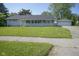 Charming single-story home with a well-manicured lawn and detached two-car garage at 11 Sayre Dr, Greenwood, IN 46143