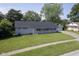 Charming single-story home with a well-maintained lawn and a detached garage on a sunny day at 11 Sayre Dr, Greenwood, IN 46143