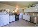 Traditional kitchen with white cabinets, black appliances, and light countertops at 11 Sayre Dr, Greenwood, IN 46143