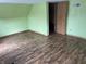 Cozy bedroom featuring wood-look floors and a standard closet at 1163 Groff Ave, Indianapolis, IN 46222