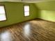 Bedroom featuring wood-look floors, neutral walls, and natural light from the windows at 1163 Groff Ave, Indianapolis, IN 46222