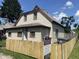 Charming home featuring light siding, a fenced yard, and professional Berkshire Hathaway signage at 1163 Groff Ave, Indianapolis, IN 46222