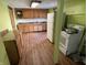 Kitchen with cabinets, appliances, and hardwood floors in need of upgrades at 1163 Groff Ave, Indianapolis, IN 46222