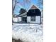 A charming two-story home with a black and white color scheme and inviting front porch at 12003 Broadway St, Indianapolis, IN 46236