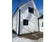 A modern home featuring a white facade and black trim, complemented by a well-kept yard at 12003 Broadway St, Indianapolis, IN 46236