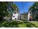 Back exterior of home with white siding and a well-manicured lawn at 12003 Broadway St, Indianapolis, IN 46236