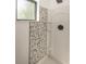 Shower featuring unique mosaic tile work next to a framed window at 12003 Broadway St, Indianapolis, IN 46236