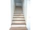 Staircase with wooden treads and white risers offers a bright and inviting transition between floors at 12003 Broadway St, Indianapolis, IN 46236
