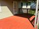 View of the back deck, with wood railings, freshly painted in a vibrant red at 1219 Lansdowne Rd, Indianapolis, IN 46234