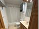 Full bathroom with vanity, medicine cabinet, shower-tub combo, and neutral tile floors at 1219 Lansdowne Rd, Indianapolis, IN 46234