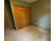 Bedroom with neutral carpet, a large closet, and olive green walls at 1219 Lansdowne Rd, Indianapolis, IN 46234