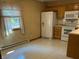 Bright eat-in kitchen with tile flooring, wooden cabinets, and neutral countertops offering ample space at 1219 Lansdowne Rd, Indianapolis, IN 46234