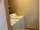 This practical laundry room features a stacked washer and dryer setup for space-saving convenience at 1219 Lansdowne Rd, Indianapolis, IN 46234
