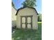 Backyard with a medium sized storage shed with wooden doors at 1219 Lansdowne Rd, Indianapolis, IN 46234