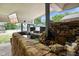 Inviting backyard featuring a serene pond, stone waterfall, outdoor seating and a mounted TV for outdoor entertainment at 12196 N Beth Ann Dr, Camby, IN 46113