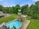 Expansive backyard with a playground, swimming pool, basketball court and surrounded by lush greenery at 12196 N Beth Ann Dr, Camby, IN 46113