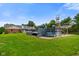 Spacious backyard with an above-ground pool, trampoline, and playground at 12196 N Beth Ann Dr, Camby, IN 46113