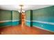 Formal dining room with decorative trim, hardwood floors, and chandelier at 12196 N Beth Ann Dr, Camby, IN 46113