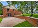 Brick exterior of the home with a large stone patio surrounded by well manicured landscaping at 12196 N Beth Ann Dr, Camby, IN 46113