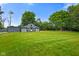 Expansive green lawn and a detached garage with matching trim and doors at 12196 N Beth Ann Dr, Camby, IN 46113
