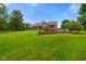 Brick home featuring a large yard, well-maintained landscaping, and basketball hoop at 12196 N Beth Ann Dr, Camby, IN 46113
