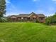 Beautifully landscaped front yard with lush green grass and mature trees at 12196 N Beth Ann Dr, Camby, IN 46113