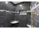 Stunning shower features black marble-look tile, built-in shelving, and gold fixtures at 12196 N Beth Ann Dr, Camby, IN 46113