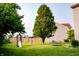 Green backyard with playset, trampoline, trees and well maintained green grass at 1242 Flatrock Dr, Anderson, IN 46013