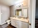 Bathroom featuring a double sink vanity with a large mirror and neutral decor at 1242 Flatrock Dr, Anderson, IN 46013