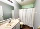 Bright bathroom featuring a bath and shower combination and an updated sink and vanity at 1242 Flatrock Dr, Anderson, IN 46013