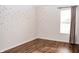 Spacious bedroom with wood flooring, natural light, and warm wall decor at 1242 Flatrock Dr, Anderson, IN 46013