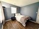 Relaxing bedroom with wood-look floors, natural lighting, and a comfortable bed at 1242 Flatrock Dr, Anderson, IN 46013