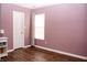 Comfortable bedroom featuring wood-look floors, neutral paint, and a single window at 1242 Flatrock Dr, Anderson, IN 46013