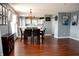 Bright dining area with laminate flooring and view to the kitchen at 1242 Flatrock Dr, Anderson, IN 46013