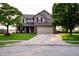 Charming two-story home with brick accents, a two-car garage, and a well-maintained front yard at 1242 Flatrock Dr, Anderson, IN 46013