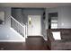Open foyer with staircase, laminate flooring, and view to a sunny window at 1242 Flatrock Dr, Anderson, IN 46013
