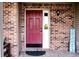 Covered front door with brick surround and decorative 'Home Sweet Home' sign at 1242 Flatrock Dr, Anderson, IN 46013
